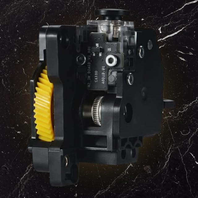Unité d’extrusion noire avec un pignon jaune, un pignon d’entraînement moleté, une petite carte électronique et une molette noire